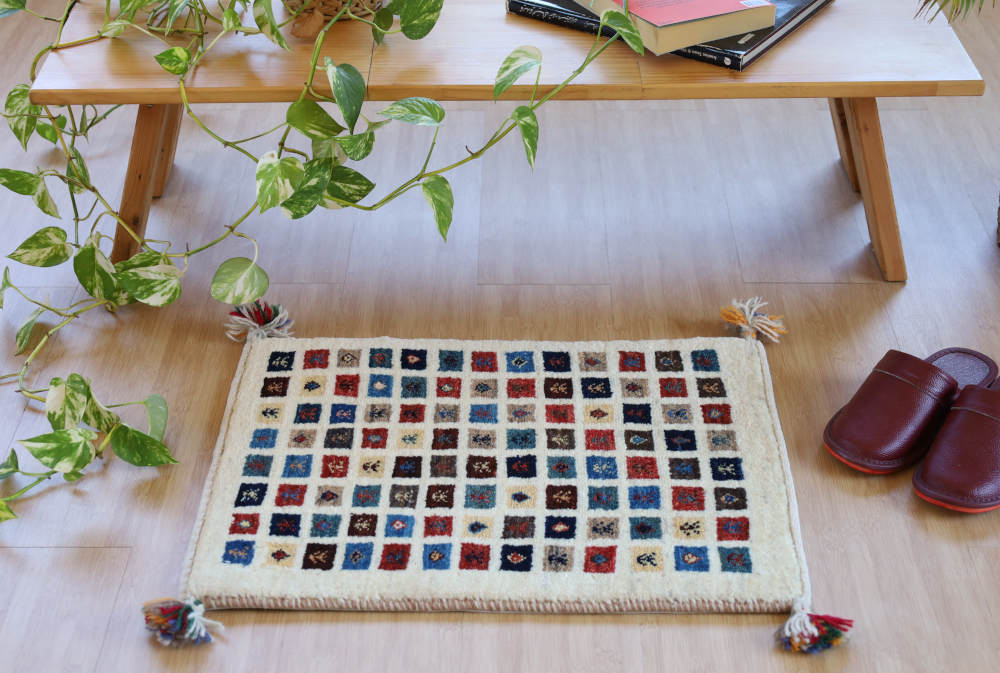 ファイン・ギャッベ（カシュクリ）のミニマット　アイボリー×ミックス色　56×42cm 部屋に敷いたイメージ